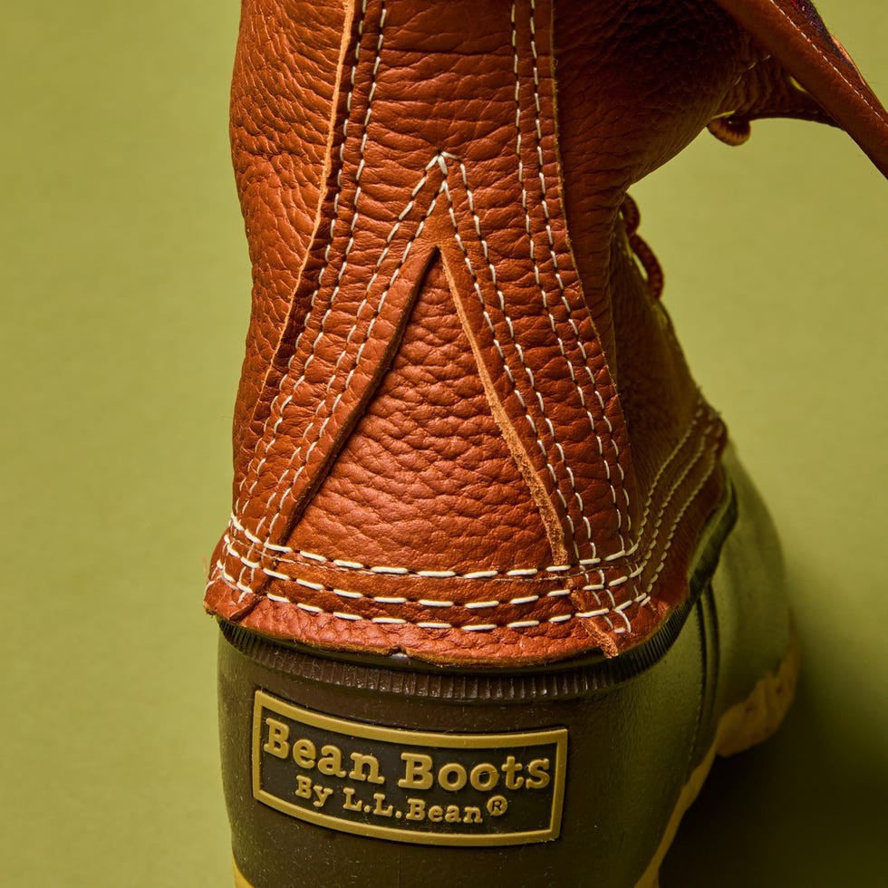 Close-up of a brown leather Bean Boot with distinctive stitching and branding by L.L.Bean.