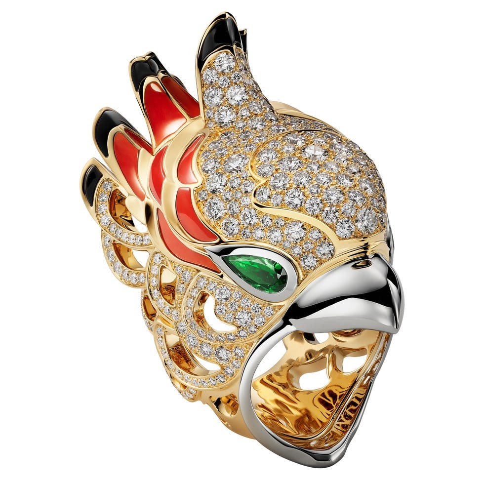A decorative ring designed as a colorful bird with gemstones and intricate detailing.