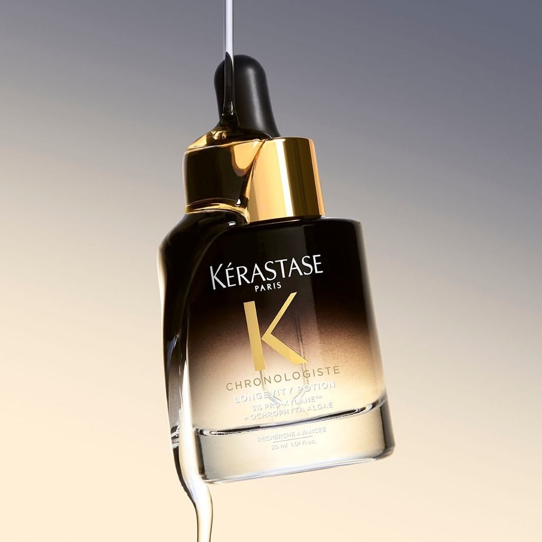 Kérastase Chronologiste hair serum bottle with dropper against a gradient background.