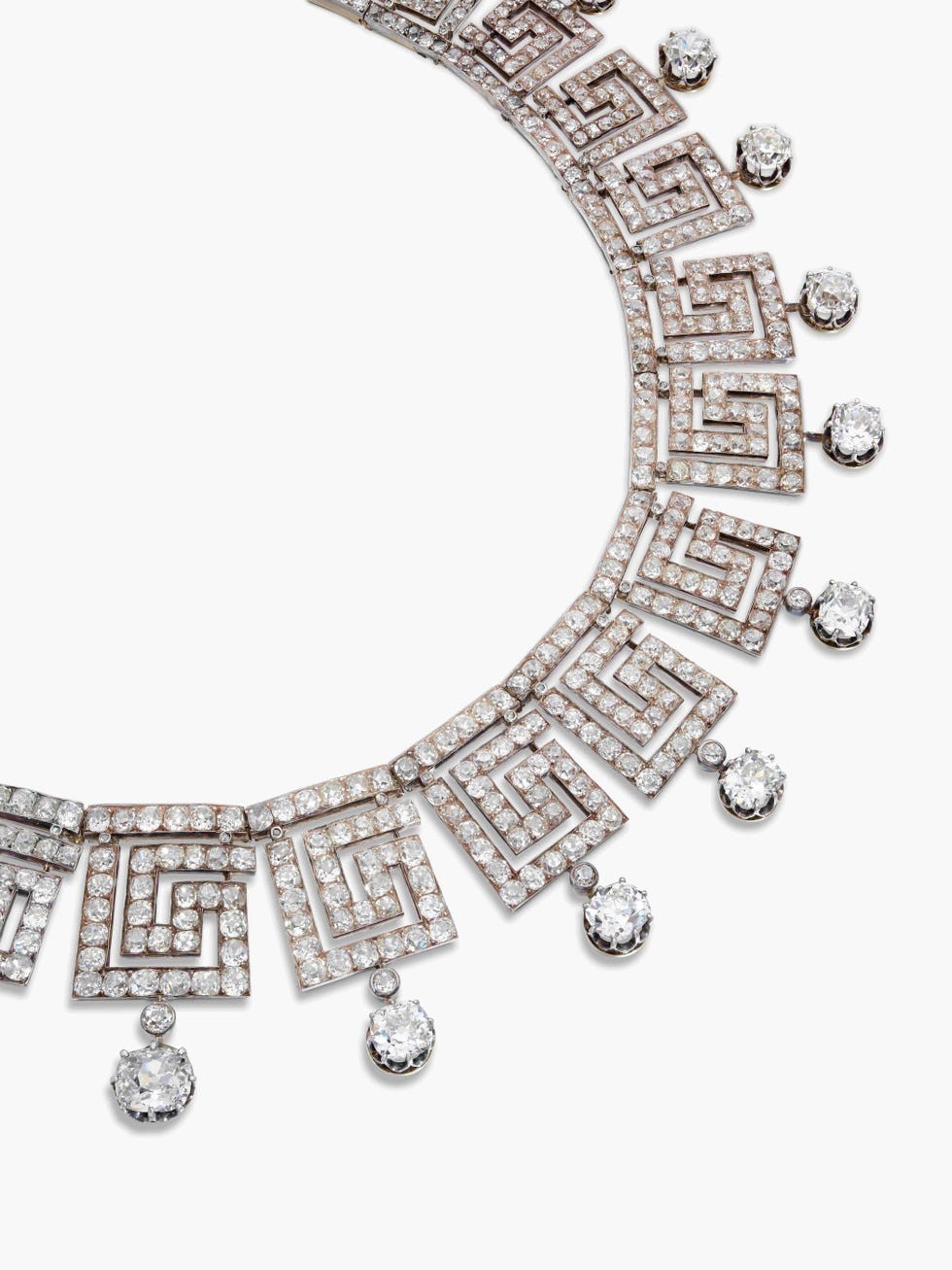 Elegant diamond necklace with geometric design and dangling crystals.