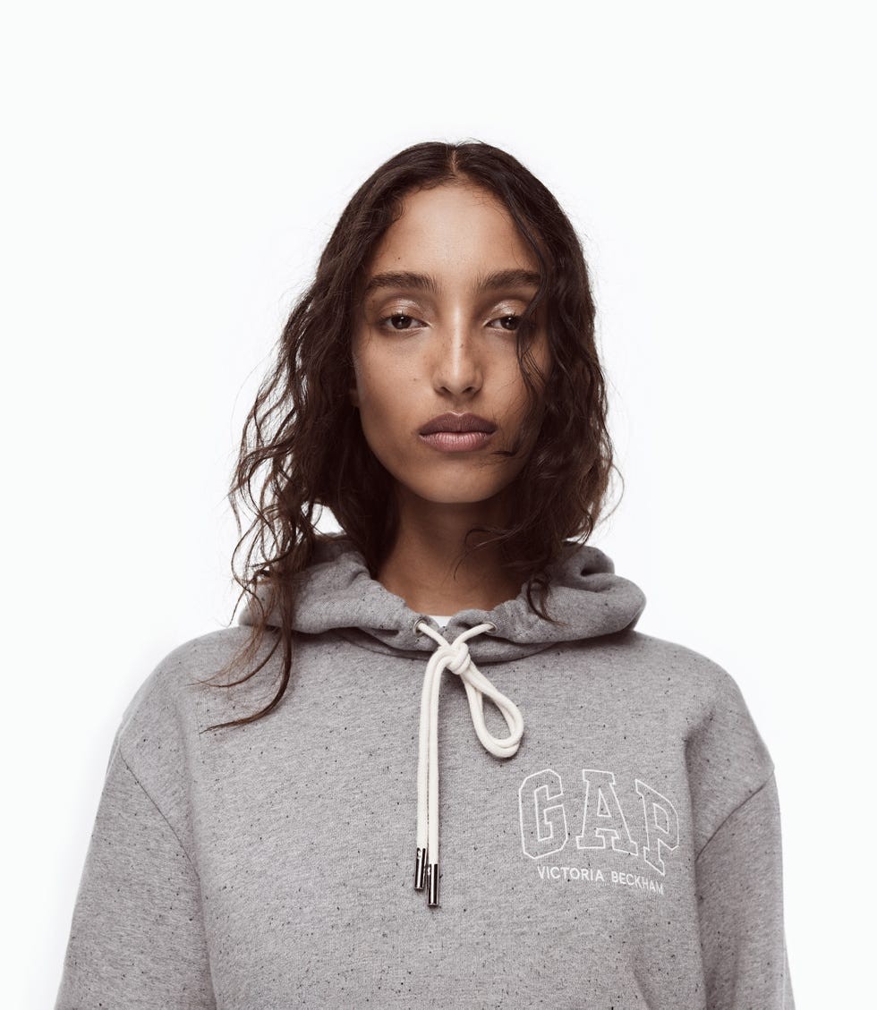 Model wearing a gray hoodie with a drawstring and GAP logo, against a white background.
