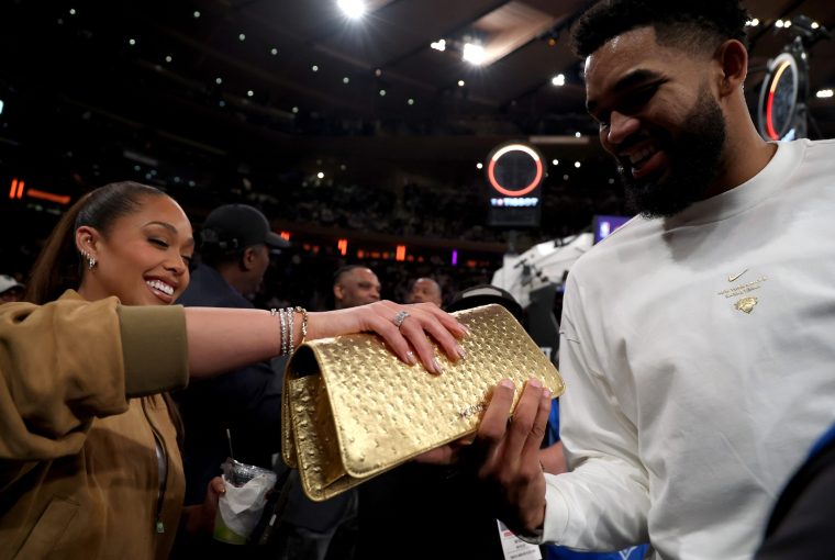new york, new york october 20 karlanthony towns 32 of the new york knicks poses with jordyn woodstownss limited edition tux clutch mini in trophy gold’ prior to the ring ceremony before the game against the philadelphia 76ers at madison square garden on october 20, 2026 in new york city note to user user expressly acknowledges and agrees that, by downloading and or using this photograph, user is consenting to the terms and conditions of the getty images license agreement photo by sarah stiergett