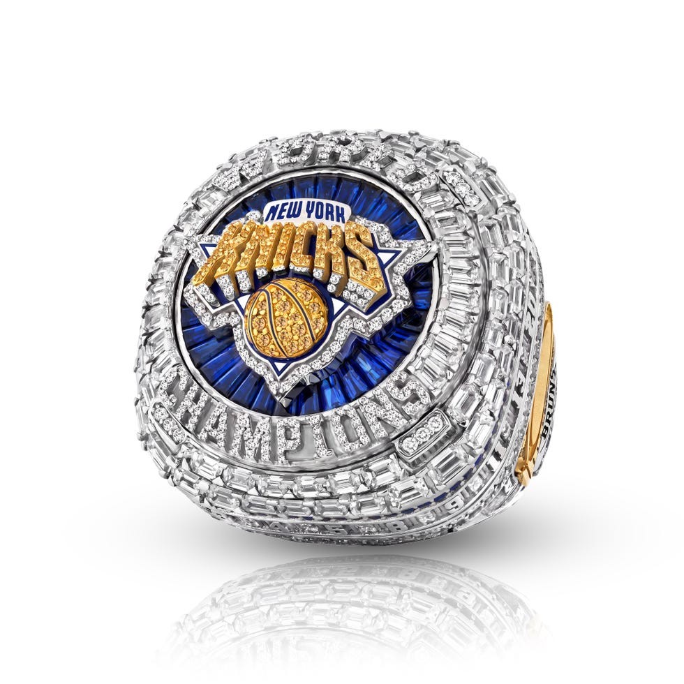 New York Knicks championship ring featuring a blue and gold design with intricate diamond detailing.