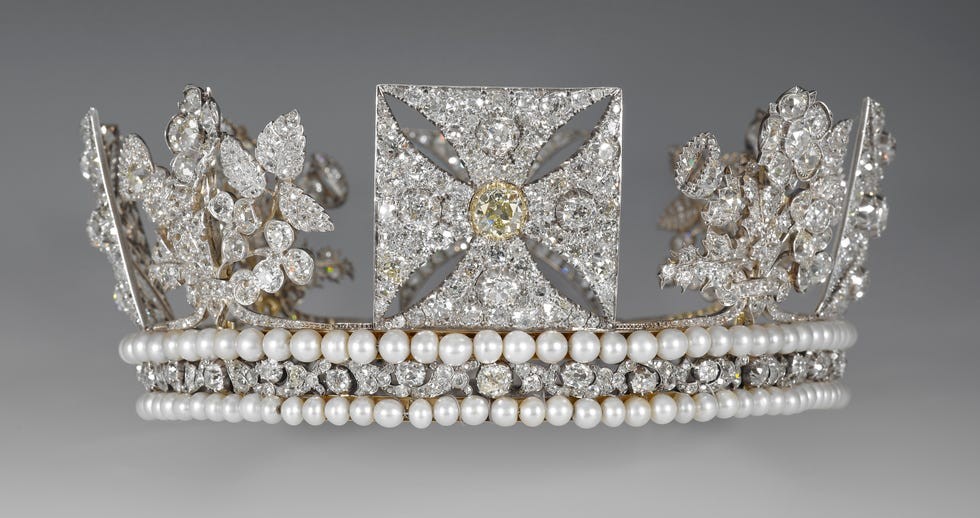 A ornate crown adorned with sparkling diamonds and pearls, featuring floral and geometric designs.