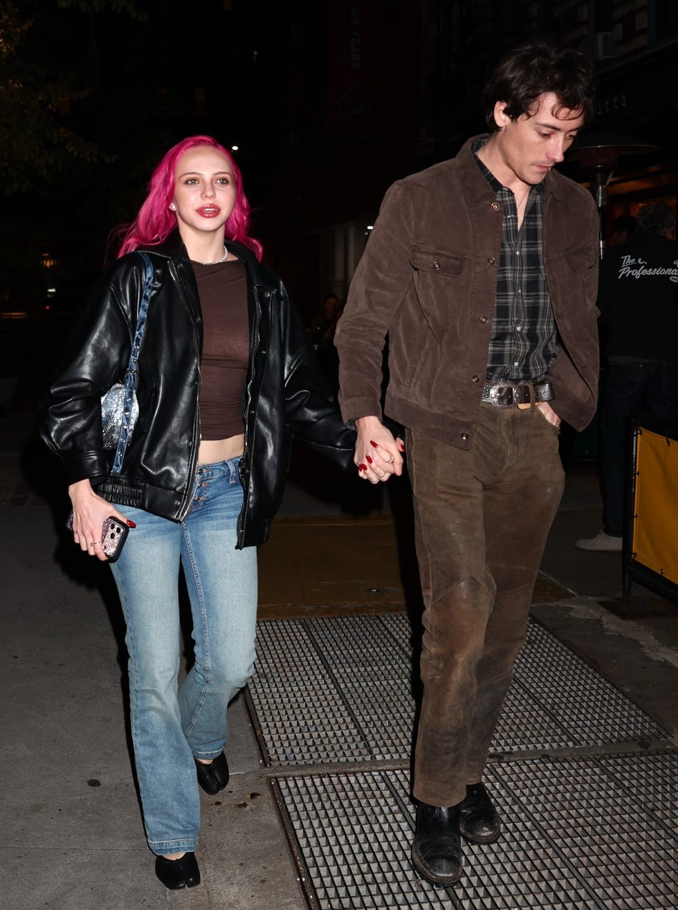 exclusive new york city, ny musician adéla and her boyfriend jackson shanks were leaving dinner at the popular restaurant bar pitti in new york city the couple stepped out for the evening meal following a performance on the tonight show starring jimmy fallon the pair held hands while walking down the sidewalk, with adéla showcasing her bright pink hair in a black leather jacket, sheer brown top, and blue jeans beside her, shanks opted for a brown suede jacket layered over a plaid shirt and brown