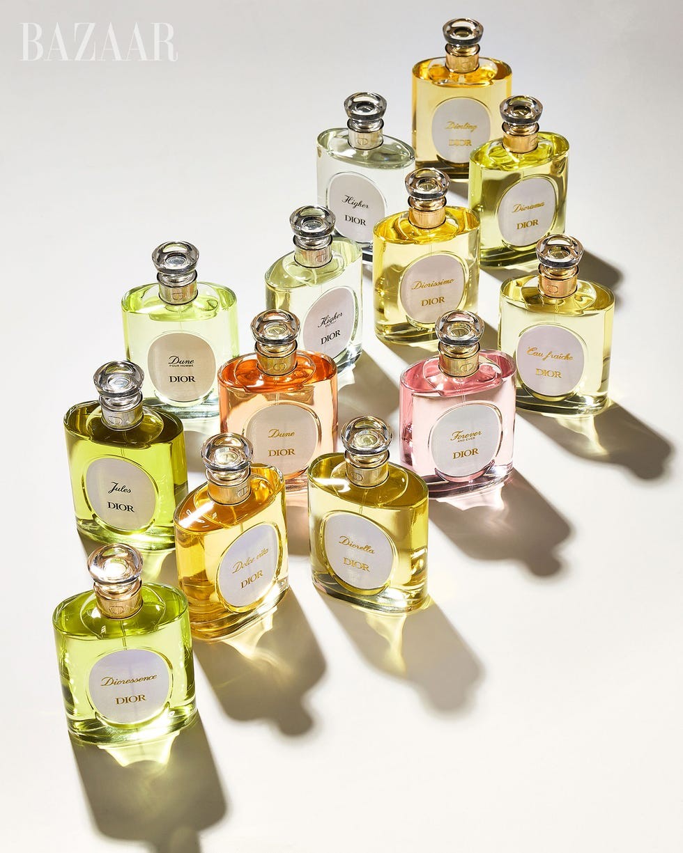 Collection of various Dior perfume bottles in different colors and shapes arranged artistically on a light background.