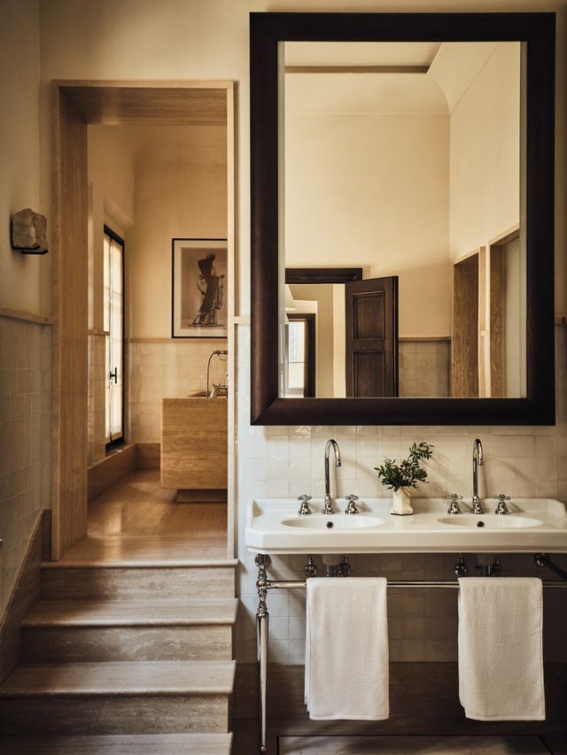 Stylish bathroom featuring a double sink, large mirror, and elegant wooden accents.