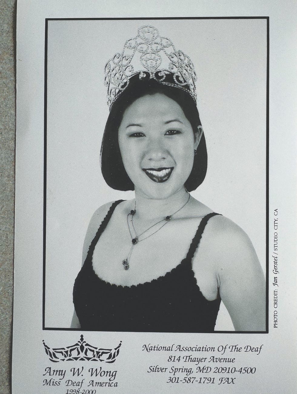 Portrait of Amy W. Wong, Miss Deaf America 1998-2000, wearing a crown and smiling for a black and white photo.