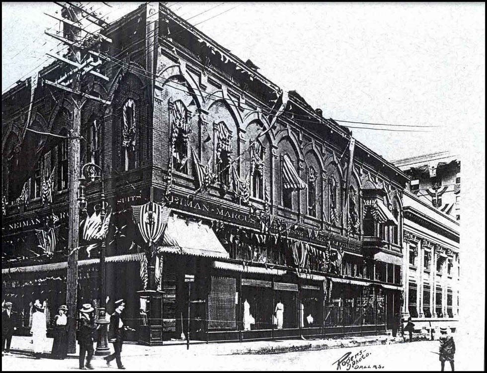 Historical storefront of Neiman-Marcus adorned with decorative flags.